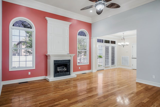 unfurnished living room featuring light hardwood / wood-style flooring, crown molding, and ceiling fan with notable chandelier