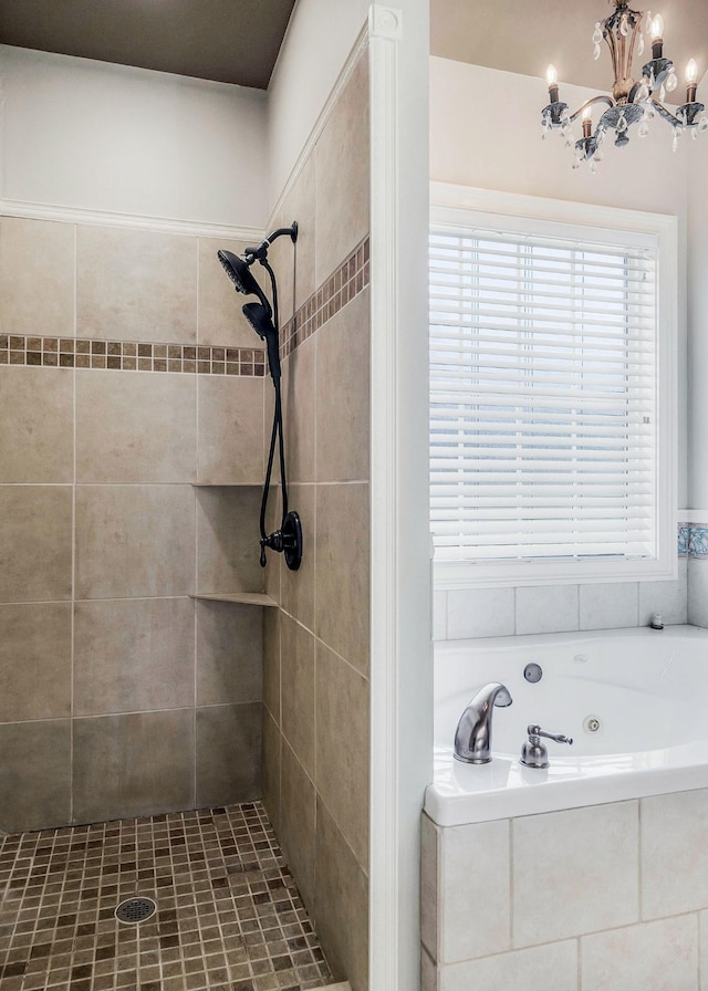 bathroom with independent shower and bath and a chandelier