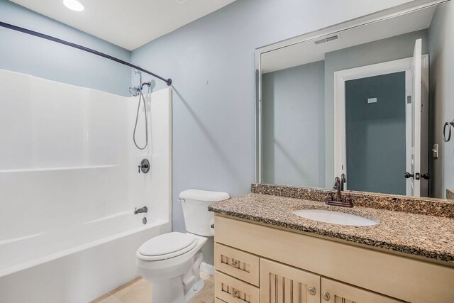 full bathroom with tile patterned flooring, shower / bathing tub combination, toilet, and vanity