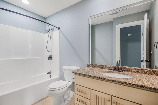 full bathroom featuring tile patterned flooring, shower / washtub combination, vanity, and toilet