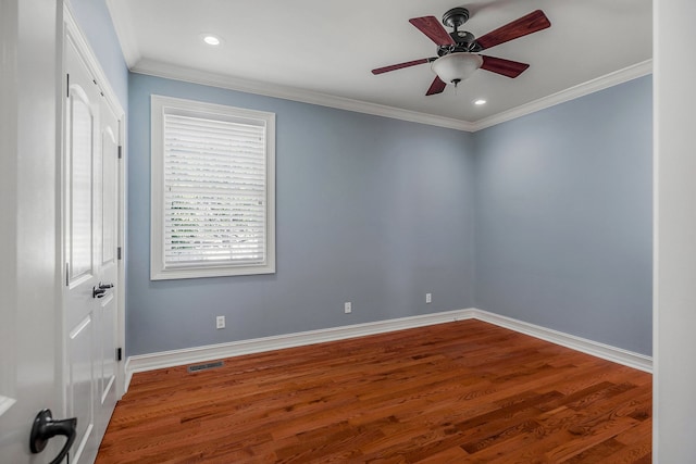 unfurnished room featuring hardwood / wood-style flooring, crown molding, and ceiling fan