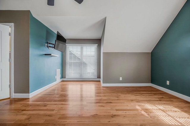 additional living space with ceiling fan, lofted ceiling, and light hardwood / wood-style floors