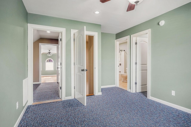 unfurnished bedroom featuring carpet, connected bathroom, and ceiling fan