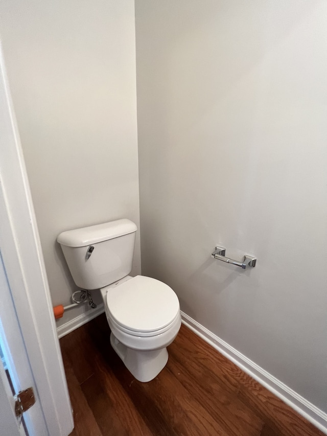 bathroom featuring toilet and wood-type flooring