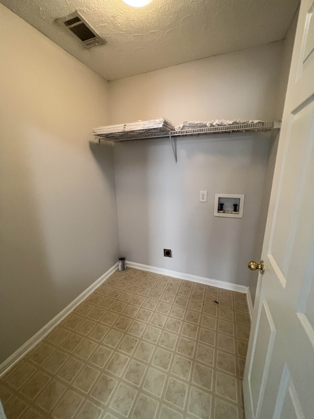 laundry room featuring hookup for an electric dryer, a textured ceiling, and washer hookup