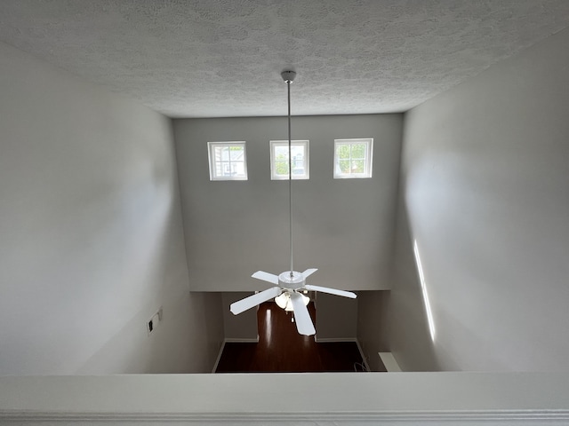 room details featuring ceiling fan, a textured ceiling, and hardwood / wood-style floors