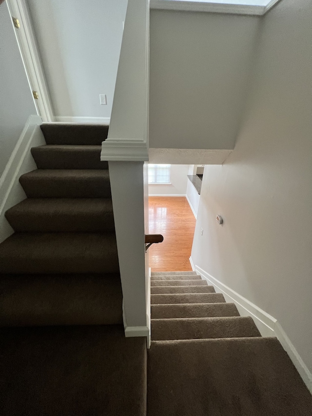 stairs with hardwood / wood-style floors