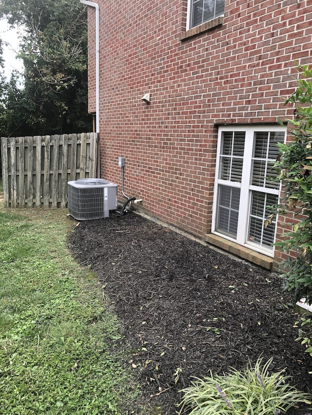 view of side of home featuring central AC