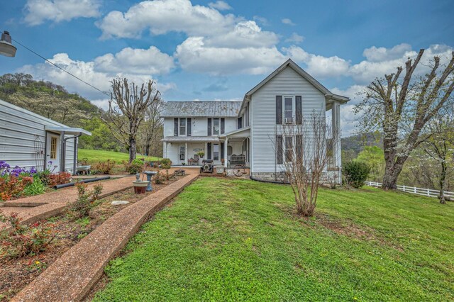 back of house with a yard