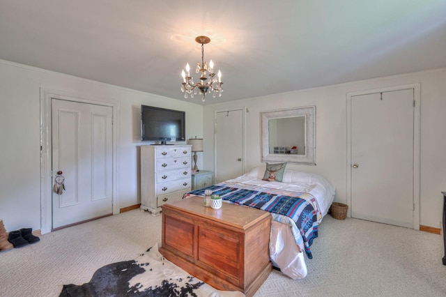 carpeted bedroom with two closets and a notable chandelier