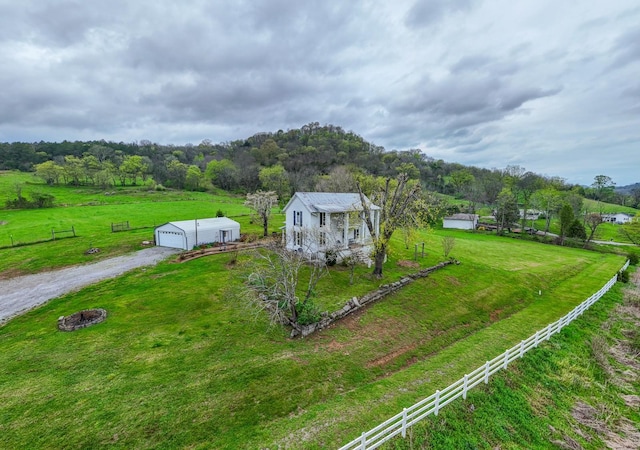 drone / aerial view featuring a wooded view and a rural view