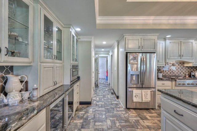 kitchen featuring wine cooler, crown molding, stainless steel appliances, dark stone countertops, and backsplash