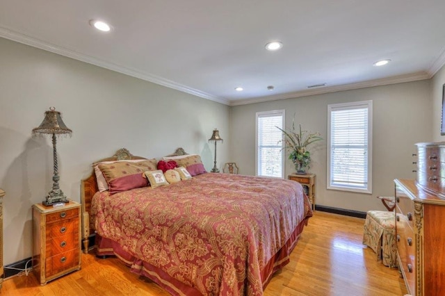 bedroom with ornamental molding and light hardwood / wood-style floors