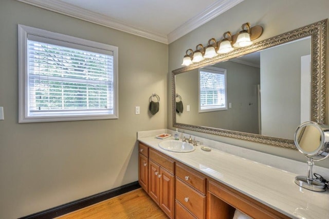 bathroom with wood-type flooring, vanity, and ornamental molding