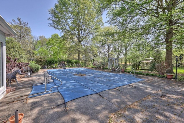 view of swimming pool with a patio