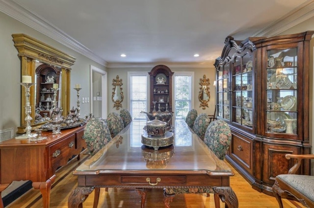 dining room featuring light hardwood / wood-style floors and crown molding