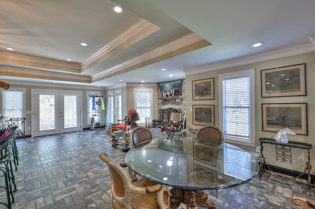 dining space with a fireplace, french doors, and a wealth of natural light