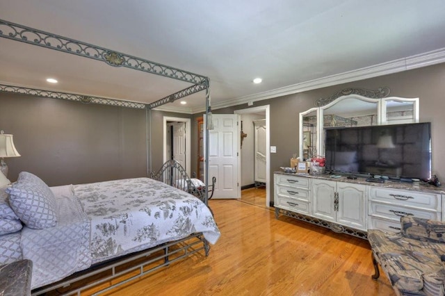 bedroom with crown molding and light hardwood / wood-style floors