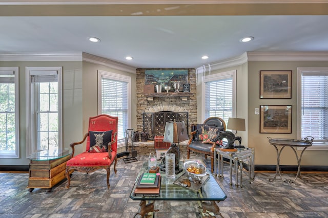 living room with crown molding, plenty of natural light, and a stone fireplace