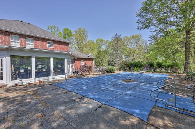 view of swimming pool with a patio area