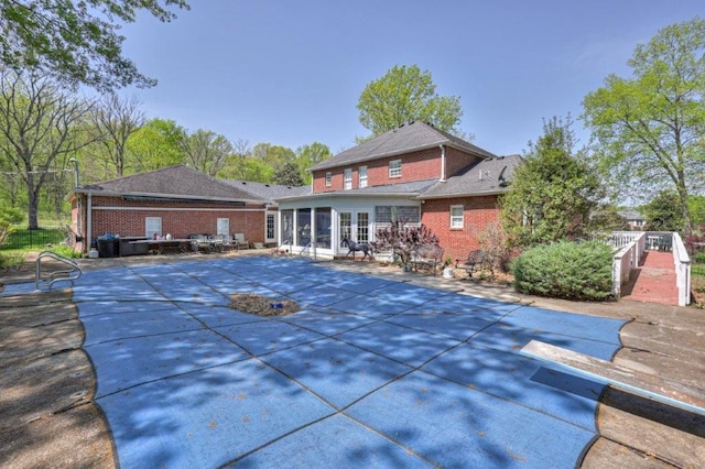 view of pool featuring a patio and a diving board