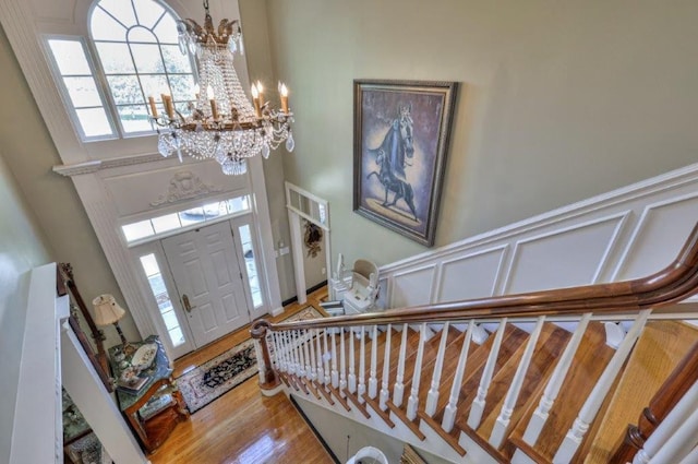 foyer with a notable chandelier, a high ceiling, and hardwood / wood-style flooring