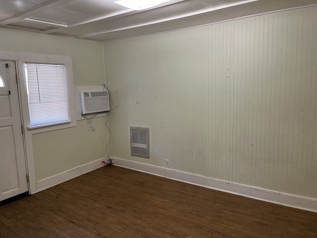 interior space featuring dark hardwood / wood-style flooring and a wall unit AC