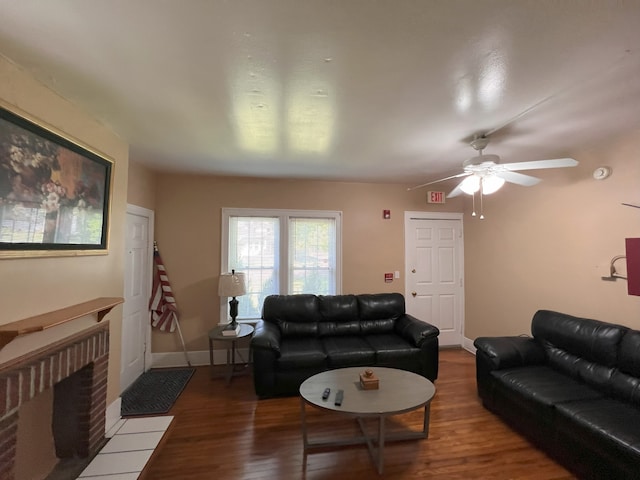 living room featuring a brick fireplace, ceiling fan, and hardwood / wood-style flooring