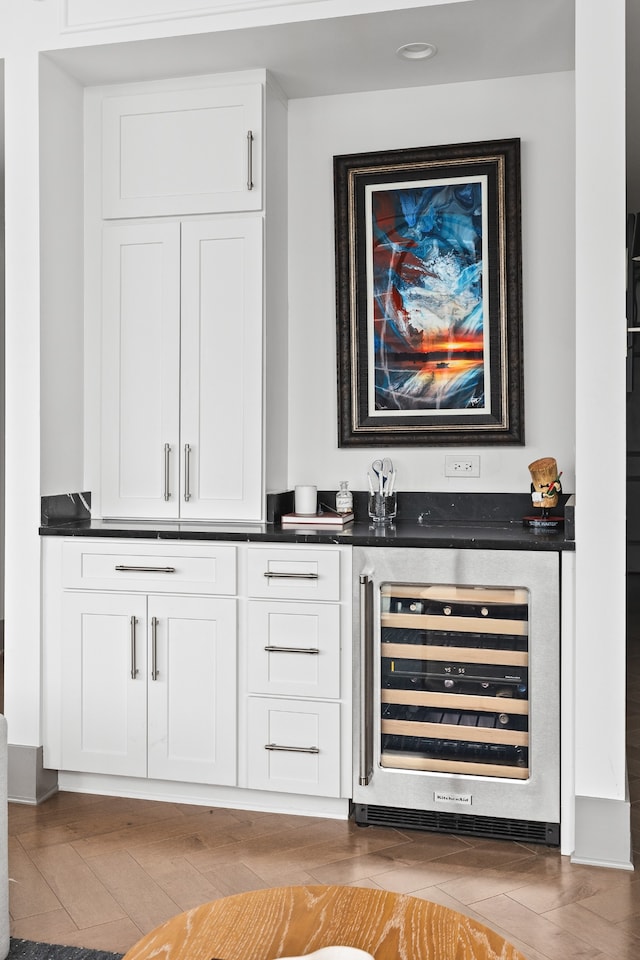 bar featuring white cabinets and beverage cooler