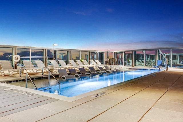 view of pool at dusk