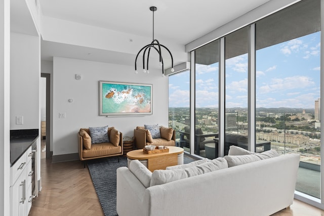 living room featuring light parquet flooring and a chandelier