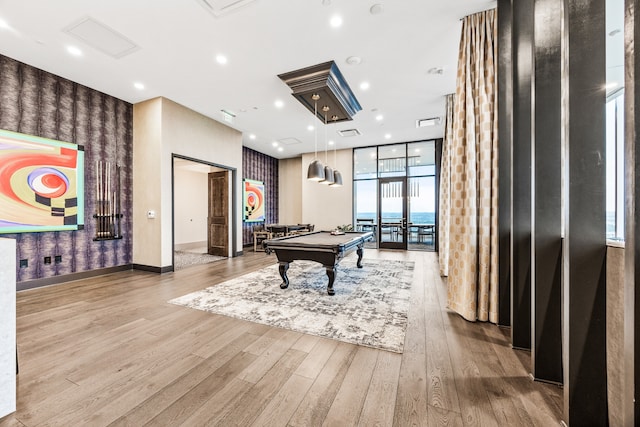 playroom with pool table, light hardwood / wood-style floors, and expansive windows