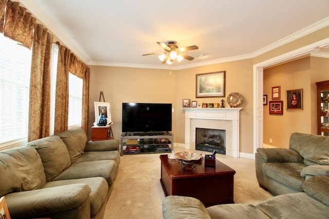 living room featuring crown molding, carpet flooring, ceiling fan, and a tile fireplace