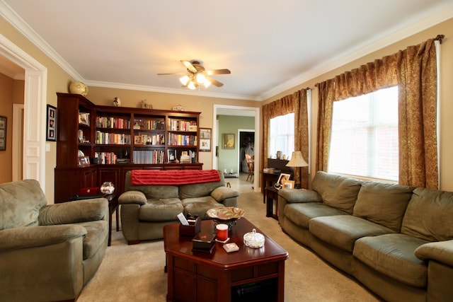 living room featuring light carpet, crown molding, and ceiling fan