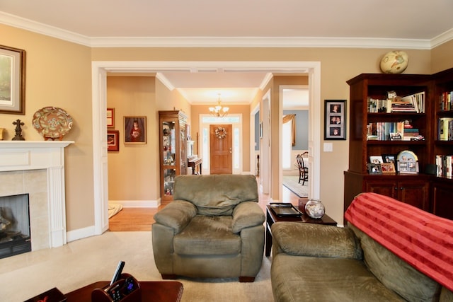 carpeted living room featuring ornamental molding, a tiled fireplace, and an inviting chandelier