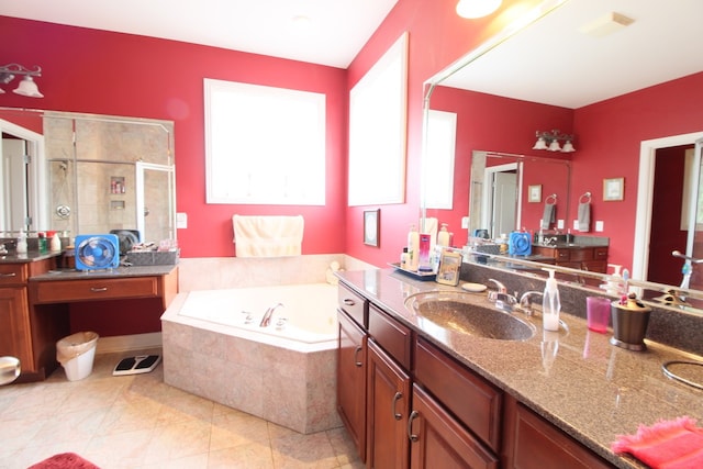 bathroom featuring tile patterned flooring, independent shower and bath, and vanity