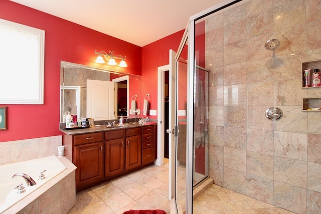 bathroom with tile patterned flooring, independent shower and bath, and vanity