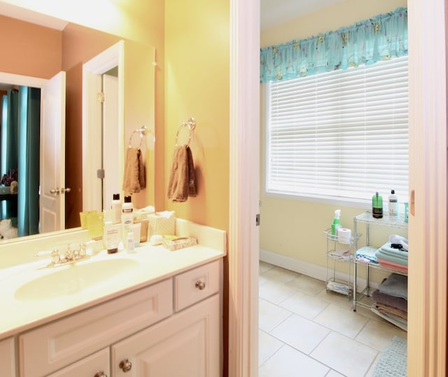 bathroom with a wealth of natural light, vanity, and tile patterned floors