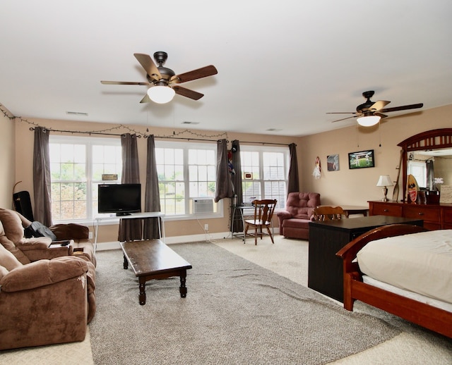 carpeted bedroom with cooling unit, ceiling fan, and multiple windows