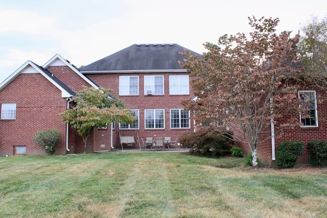 view of front facade with a front lawn and a patio