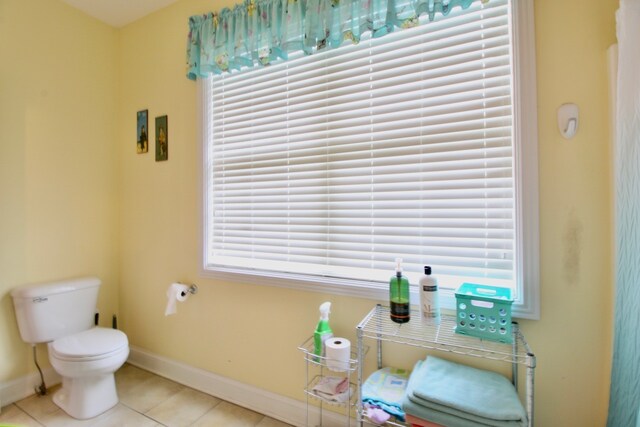 bathroom featuring toilet and tile patterned flooring