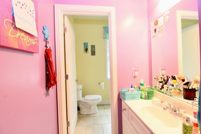 bathroom with vanity, toilet, and tile patterned floors