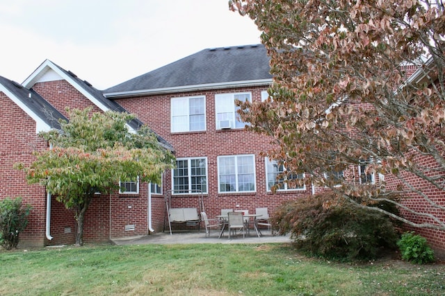 back of property featuring a lawn and a patio