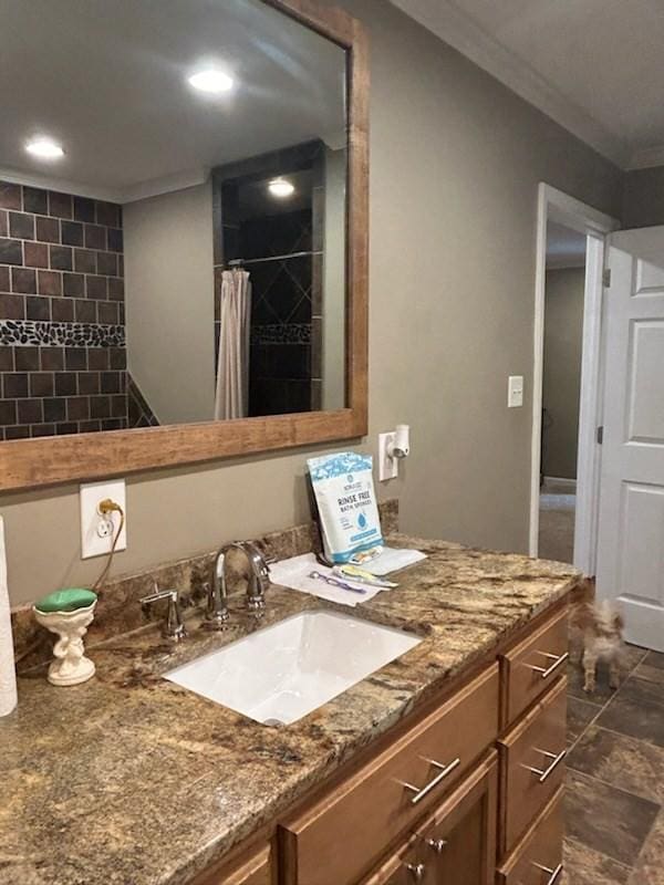 bathroom with walk in shower, ornamental molding, and vanity