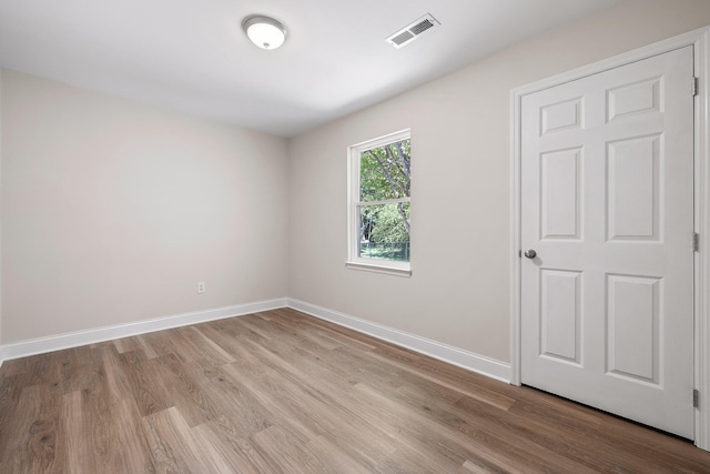 unfurnished room featuring hardwood / wood-style flooring