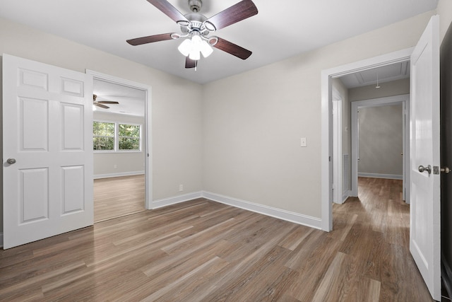 unfurnished room with ceiling fan and hardwood / wood-style flooring