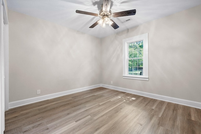 spare room with ceiling fan and wood-type flooring