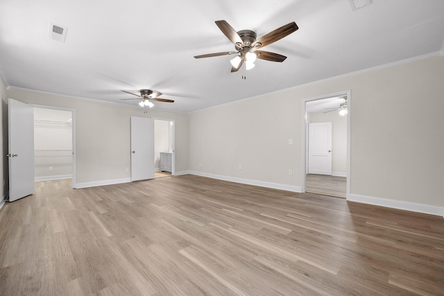 empty room with ceiling fan, crown molding, and light wood-type flooring