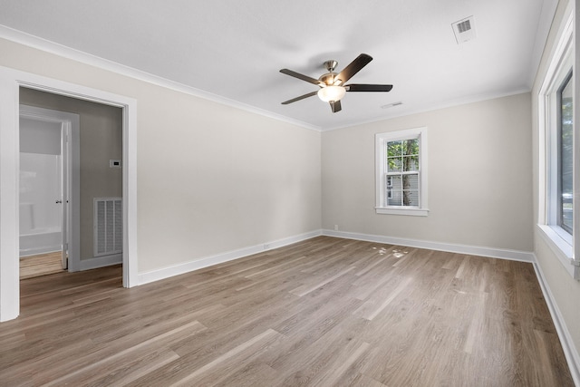 unfurnished room featuring ceiling fan, ornamental molding, and hardwood / wood-style flooring