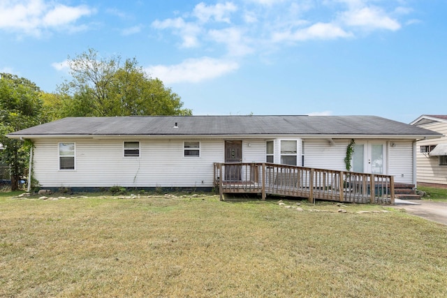 back of property featuring a lawn and a deck